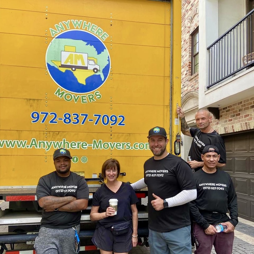 Anywhere Movers crew in branded shirts in front of the truck